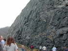 I 26 Tn-NC border road cut exposing a mix of metamorphosed sedimentary rocks intruded by granite.  The ages and names of the units involved may determined from local roadside maps of the geology