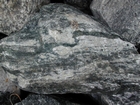 I 26 Tn NC border Metamorphics - Rip rap fill - loose block of Foliated Gneiss characterized by dark minerals that include amphiboles, biotite mica and white minerals which are a mix of feldspars and quartz