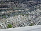 Pound Gap where the uppermost portion of the Mississippian Grainger Formation is here composed of alternating relatively continuous to occasionally shallowly channeled beds of sand with uniform sharp bedding planes and shale; both lithologies vary in thickness and the sands often exhibit Bouma sequences suggesting deposition from turbidite currents that were active over a mid to outer fan setting. The top of the photograph is marked by the overlying Lower Mississippian Newman Limestone Formation