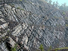 Pound Gap where the upper portion of the thin bedded Mississippian Grainger Formation is composed of alternating thin sands and shale and the middle portion composed of varying thicknesses of sand separated by bedding planes marked by thin shale