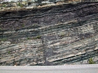 Pound Gap where the lower portion of the thin bedded Mississippian Grainger Formation is composed of alternating thin sands and shale and the overlying middle portion is composed of varying thicknesses of sand separated by bedding planes marked by thin shale