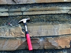 Pound Gap where bedding character of the middle portion of the Mississippian Grainger Formation sands exhibits Bouma sequences, suggesting deposition from turbidite currents that were active over a mid to outer fan setting. Hummocky character of sand bed tops may be related to wave erosion