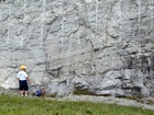 Contact between top of unit 111 and bottom of 110, see the measured Geological Section, Kentucky Geological Survey Field Trip Guide 1998. This has horizontal to slightly dipping thin bedding of the shallow water limestones of the Lower Mississippian Newman Limestone Formation. Close to the top of the photograph are cross beds inclined to the left suggesting that migrating shallow channels moved through this setting. The horizontal to slightly dipping thin bedding suggests accumulation in a swash zone or just seaward