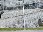 Lower/dark layer marks top of unit 110 and base of 109, see the measured Geological Section, Kentucky Geological Survey Field Trip Guide 1998. Storm wave base is giving these shallow water limestones of the Lower Mississippian Newman Limestone Formation their irregular fill character in conjunction with low angle cross beds or mound margin clinoforms indicating migrating carbonate bodies moving in this setting. Note the two prominent dolomitized silts