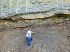 Details of the Pound Gap eroded contact between the interbedded sands and shales of the Mississippian Grainger below and the overlying Lower Mississippian Newman Limestone Formation. Note the chocolate colored dolomite horizon just above the contact. The limestone have irregular but sharp bedding planes. Dr. Abdulrahman Alissa when he was a graduate student and a scale