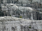 Storm waves are interpreted to have eroded this shelf surface and caused the shallow water limestones of the Lower Mississippian Newman Limestone Formation to have their irregular character, while local currents account for the development of low angle cross beds and mound margin clinoforms suggesting migrating carbonate bodies moving across this setting. Major portion of bottom foreground is unit 105, but the extent of 104 above has not been established in this image, see the measured Geological Section, Kentucky Geological Survey Field Trip Guide 1998