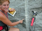 Interbedded intraclastic packstone and mudstone fabric rich in bioclasts including cross sections of the plates of bryozoan crust that look like the carapaces of giant coarse trilobites (shepherds crooks in cross section) in the Lower Mississippian Newman Limestone Formation. These sediments probably accumulated where storm wave erosion occurred just seaward of the shoreface, with waves driving local transport of this sediments across this shelf surface and causing the local irregular eroded character of the bedding planes.Unit 101, see the measured Geological Section, Kentucky Geological Survey Field Trip Guide, 1998