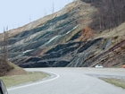 Crest of Pound Gap at the Rt 23 Road Cut where a quartz arenite sandstone marks the top of the road cut. This is tentatively interpreted to be the Lower Pennsylvanian Warren Point Sandstone by Greb, (1998), (Figures 051 052) forming the lower part of the Lee Formation of the Breathit Group. The Warren Point Sandston unconformably overlies the Upper Mississippian Pennington Formation (Figures 049, 050 and 051