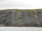 Exposures of Upper Clare Shale overlain by Ross Formation in the cliffs west of Bromore West and Drom in Co Kerry. These Namurian outcrops are south of Kilconly best seen from the Shannon Estuary. The shales evolve upward in depositional setting from a deeper euxinic setting with an influx of shales that upward change to turbiditic sands (Rider, 1969, and Martinsen, 1989).