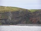 Exposures of Lower to Middle Ross Formation in the cliffs west and south of Drom in Co Kerry. These Namurian outcrops are south of Kilconly best seen from the Shannon Estuary. The depositional setting is expressed by the turbiditic sands of the cliffs(Rider, 1969, Martinsen, 1989; and Pyles, 2007).