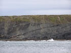 Exposures of Lower to Middle Ross Formation in the cliffs west and south of Drom in Co Kerry. These Namurian outcrops are south of Kilconly best seen from the Shannon Estuary. The depositional setting is expressed by the turbiditic sands of the cliffs(Rider, 1969, Martinsen, 1989; and Pyles, 2007).