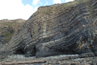 Exposures of Ross Formation in cliffs at Leck Point with its ruined Castle west and south of Drom in Co Kerry (Pyles, 2007). These Namurian outcrops of turbiditic sands are accessed by road and then a gulley to the beach through the cow pastures at Drom.