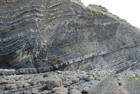 Exposures of Ross Formation in cliffs at Leck Point with its ruined Castle west and south of Drom in Co Kerry (Pyles, 2007). These Namurian outcrops of turbiditic sands are accessed by road and then a gulley to the beach through the cow pastures at Drom.