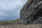 Exposures of Ross Formation in cliffs at Leck Point with its ruined Castle west and south of Drom in Co Kerry (Pyles, 2007). These Namurian outcrops of turbiditic sands are accessed by road and then a gulley to the beach through the cow pastures at Drom.