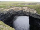 Upper Carboniferous Ross Sandstone formation eroded by wave action to leave a standing arch of sand or 