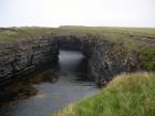 Upper Carboniferous Ross Sandstone formation eroded by wave action to leave a standing arch of sand or 