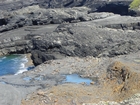 Cliffs and eroded bedding planes of the coastal monocline of Namurian deepwater sediments of the Ross Formation just south of Fisherman's Point. In foreground are bedded and slumped sediments of the Ross Formation.