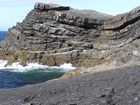 Exposed in the flank of a monocline are the Fisherman's Point Namurian deepwater sediments. Note the cut and fill of channeled Ross Formation. Channel fill overtops the channeling forming winged onlapping overbank sands.