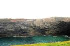 Cliff of Gull Island Formation composed of mixed channel sands and lobes and large deformational structures interpreted to have been transported downslope from a deltaic source above. Note large filled channel cut into rhythmic slope deposits of silt and mud.