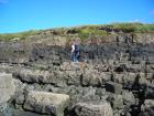 Kilbaha Bay details of outcrop of channeled Mid-Ross Sandstone Formation in the low cliffs above the wave cut pavement of the intertidal zone,