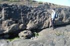 Amalgamated deepwater channeled sands of the Ross Formation interbedded with shale. At base of the ledge is a chute scour surface beneath the deepwater channel fill.