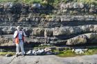 At base of the ledge in the mid foreground is a chute scour filled by deepwater interbeds of thin sands and shale. The top of section exhibits sand lobes and interbeds of shale,