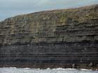 Kilclogher Cliffs exposing deepwater sandstone lobes of the Ross Formation. In the section below are thinner bedded more distal portions of lobes while above are thicker bedded sands towards axies of the lobes.