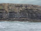 Kilclogher Cliffs exposing deepwater sandstone lobes of the Ross Formation. In the section below are thinner bedded more distal portions of lobes while above are thicker bedded sands towards axies of the lobes.