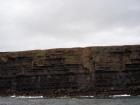 Kilclogher Cliffs exposing deepwater sandstone lobes of the Ross Formation. In the section below are thinner bedded more distal portions of lobes while above are thicker bedded sands towards axies of the lobes.