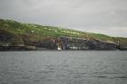 East end of the Kilclogher Cliffs exposing deepwater sandstone lobes of the Ross Formation. At the base of the section are thinner bedded more distal portions of lobes. Above in grass cover are thicker bedded amalgamated channeled sands more proximal to the axies of deepwater lobes.