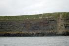 Kilclogher Cliffs exposing deepwater sandstone lobes of the Ross Formation. At the base of the section are thinner bedded more distal portions of lobes subdiveded by a thicker bedded amalgamated channeled sand. Above in the grass cover are thicker bedded amalgamated channeled sands more proximal to the axies of deepwater lobes.