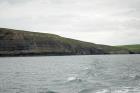 East end of the Kilclogher Cliffs towards the Rehy Cliffs exposing deepwater sandstone lobes of the Ross Formation. At the base of the section are thinner bedded more distal portions of lobes. Above in grass cover are thicker bedded amalgamated channeled sands more proximal to the axies of deepwater lobes.