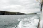 East end of the Kilclogher Cliffs and in distance to right are the Rehy Cliffs exposing deepwater sandstone lobes of the Ross Formation. At the base of the section are thinner bedded more distal portions of lobes. Above in grass cover are thicker bedded amalgamated channeled sands more proximal to the axies of deepwater lobes.