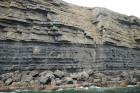 Kilclogher Cliffs exposing deepwater sandstone lobes of the Ross Formation. At the base of the section is an amalgamated axial channel fill. Above which are thinner bedded more distal portions of lobes capped by thicker bedded sands towards axies of the lobes.