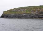 Kilcredaun Cliffs in the vicinity of the Kilcredaun lighthouse. Outcropping in these cliffs are thin bedded turbidite channel fill and turbidite sand lobes in the Upper Carboniferous Namurian Ross Formation. Photographs taken from the fishing vessel Draiocht out of Carrigaholt on the northern shore of the Shannon Estuary.