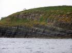 Kilcredaun Cliffs in the vicinity of the Kilcredaun lighthouse. Outcropping in these cliffs are thin bedded turbidite channel fill and turbidite sand lobes in the Upper Carboniferous Namurian Ross Formation. Photographs taken from the fishing vessel Draiocht out of Carrigaholt on the northern shore of the Shannon Estuary.