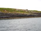 Kilcredaun Cliffs in the vicinity of the Kilcredaun lighthouse. Outcropping in these cliffs are thin bedded turbidite channel fill and turbidite sand lobes in the Upper Carboniferous Namurian Ross Formation. Photographs taken from the fishing vessel Draiocht out of Carrigaholt on the northern shore of the Shannon Estuary.