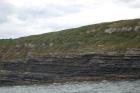 Kilcredaun Cliffs in the vicinity of the Kilcredaun lighthouse. Outcropping in these cliffs are thin bedded turbidite channel fill and turbidite sand lobes in the Upper Carboniferous Namurian Ross Formation. Photographs taken from the fishing vessel Draiocht out of Carrigaholt on the northern shore of the Shannon Estuary.