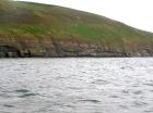 Rehy Cliffs exposing two channelled amalgamated deepwater fills, offset from each other. The lower channel is just above present sea level, highlighted by gull droppings. Ross Sandstone probably in mid fan position towards center of fan body.