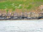 Rehy Cliffs exposing two channelled amalgamated deepwater fills, offset from each other. The lower channel is just above present sea level, highlighted by gull droppings. Ross Sandstone probably in mid fan position towards center of fan body.