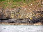 East end of Rehy Cliffs with detail of monoclinical fold in deepwater Ross Formation sands. To left are two channelled amalgamated deepwater fills, offset from each other. The lower channel is just above present sea level. Ross Sandstone probably in mid fan position towards center of fan body.