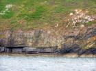 East end of Rehy Cliffs with detail of monoclinical fold in deepwater Ross Formation sands. To left are two channelled amalgamated deepwater fills, offset from each other. The lower channel is just above present sea level. Ross Sandstone probably in mid fan position towards center of fan body.