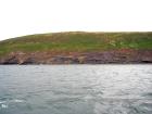 East end of Rehy Cliffs beyond monoclinical fold in deepwater Ross Formation sands. The interbedded shales and sands suggest a more distal position at the edge of a deepwater fan body.