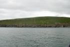 Rehy Cliffs exposing two channelled amalgamated deepwater fills, offset from each other. The lower channel is just above present sea level, highlighted by gull droppings. Ross Sandstone probably in mid fan position towards center of fan body.