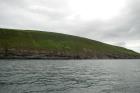 Rehy Cliffs exposing two channelled amalgamated deepwater fills, offset from each other. The lower channel is just above present sea level, highlighted by gull droppings. Ross Sandstone probably in mid fan position towards center of fan body.