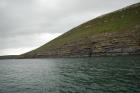 Rehy Cliffs exposing two channelled amalgamated deepwater fills, offset from each other. The lower channel is just above present sea level, highlighted by gull droppings. Ross Sandstone probably in mid fan position towards center of fan body.