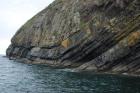 East end of Rehy Cliffs with detail of monoclinical fold in deepwater Ross Formation sands. To left are two channelled amalgamated deepwater fills, offset from each other. The lower channel is just above present sea level. Ross Sandstone probably in mid fan position towards center of fan body.