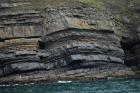 West end of Rehy Cliffs showing a thin bedded inter channel area at western feather edges of deepwater channel wings. Overlying a filled channel in mid section are downlapping clinoformed sands of interior channel margin. Ross Formation sands probably in mid fan position on edge of the fan body.