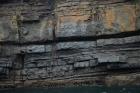 West end of Rehy Cliffs showing a thin bedded inter channel area at western feather edges of deepwater channel wings. Overlying a filled channel in mid section are downlapping clinoformed sands of interior channel margin. Ross Formation sands probably in mid fan position on edge of the fan body.