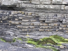 Deepwater lobes of Ross Formation form irregularly bedded sandstone sheets that pinch and swell. Interfingering shale rich intervals contain flazered structures of high energy sandstone ripples in the shale to silt matrex. These structures are the products of bursts of rapid deepwater currents transporting the sands from the adjacent sand lobes and the basin margin.